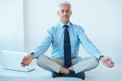 Buy stock photo Full length shot of a mature businessman sitting cross legged and meditating