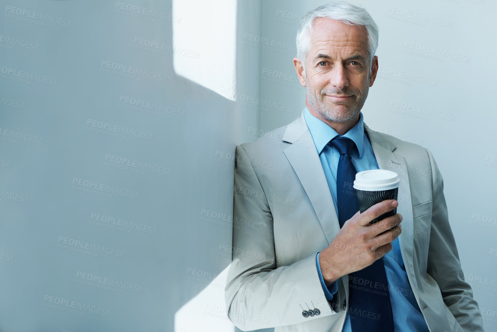 Buy stock photo Portrait of a mature businessman drinking a take-away cup of coffee