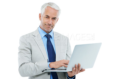 Buy stock photo Studio shot of a mature businessman working on a laptop isolated on white