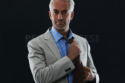Buy stock photo Fashion, portrait and businessman with tie in studio with classy, elegant and corporate suit. Style, serious and professional mature male person undressing with outfit by dark black background.