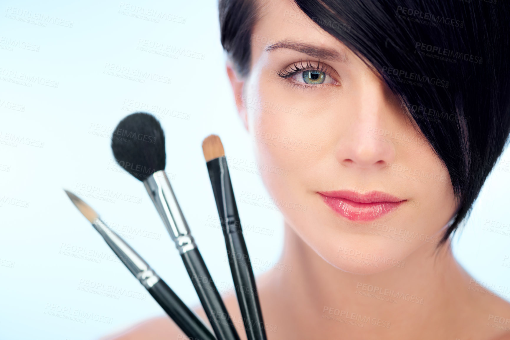 Buy stock photo Woman, portrait and makeup brushes in studio with beauty, cosmetic tools or product application for skincare. Model, face and confidence with skin wellness, cosmetology or grooming on blue background