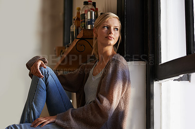 Buy stock photo An attractive young woman sitting on the floor at home