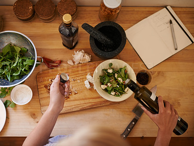 Buy stock photo High angle shot of a woman preparing a salad in a kitchen