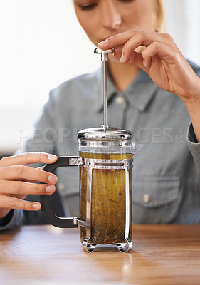Buy stock photo Woman, closeup or herbal tea to relax in home and warm beverage of herbs mixture in plunger for health. Herbalist, drink or creative idea for dry leaves and wellness for detox liquid on kitchen table