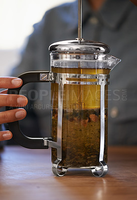 Buy stock photo Closeup, person and hands with tea plunger for brewing, heathy and fresh beverage start morning. Cafe, table and prepare for customers on breakfast to taste, drink and enjoy for beautiful day. 