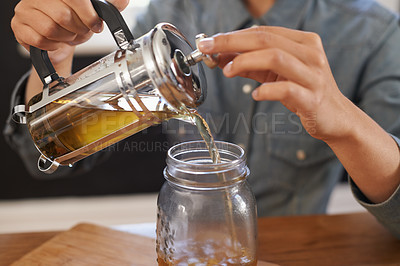 Buy stock photo Closeup, person and hands with brewing tea to start morning, cafe and table before work. Plunger, pour, fresh and healthy beverage for customer on breakfast, teapot and drink to enjoy beautiful day 