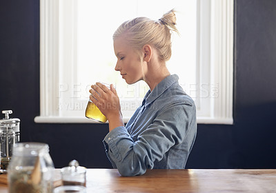 Buy stock photo A young woman making herbal tea
