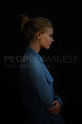 Buy stock photo Woman, profile and thinking of calm thoughts on a dark or black background to remember a memory. Female model in studio as wise, inspire and casual outfit with a smile, arms crossed and pensive