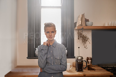 Buy stock photo Portrait of a beautiful young woman standing in the kitchen