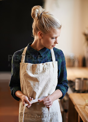 Buy stock photo Chef, woman and tie apron in restaurant, kitchen or catering service at hotel for gastronomy. Uniform, cooking and person fasten clothes, culinary and preparation of professional waitress at job