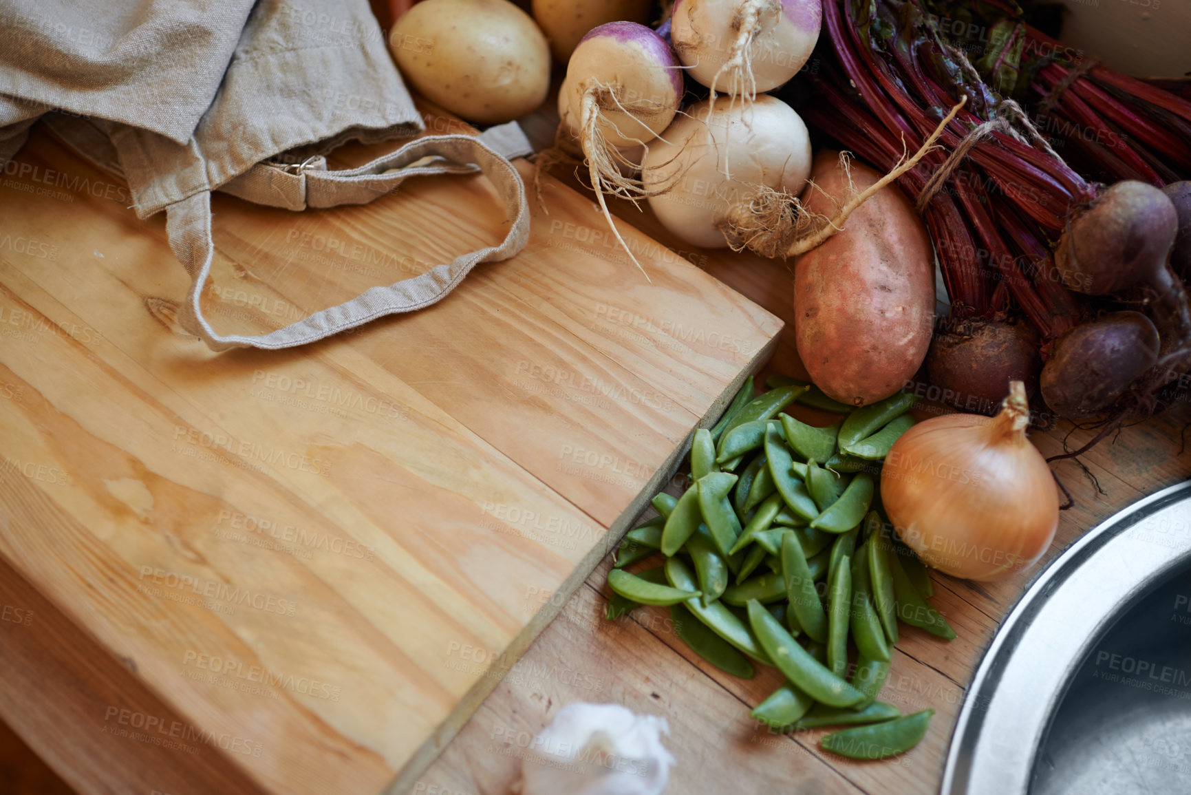 Buy stock photo Vegetables, vegan and wooden board for cooking lunch, dish and nutrition for diet at home. Wellness, health and organic food with meal, vegetarian and green ingredients for salad in a kitchen