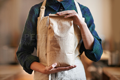 Buy stock photo Barista woman, hands and bag while in an apron in  background at home. Close up of female worker wearing pinafore and holding craft paper order while packaging coffee beans as small business owner