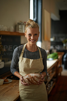 Buy stock photo Portrait of a young female baker holding homemade bread