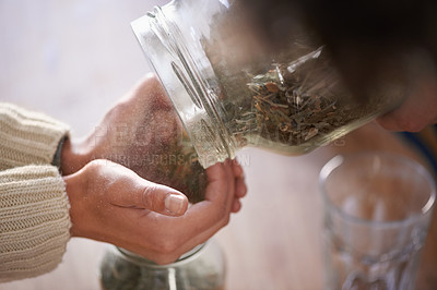 Buy stock photo Hands, jar and tea leaves for herbal drink in kitchen for healthy benefits for beverage or hibiscus, jasmine or preparation. Person, fingers and chamomile for peaceful morning, vitality or wellness
