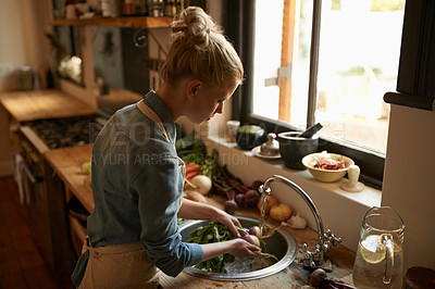 Buy stock photo Woman in kitchen, cleaning vegetables and cooking, hygiene and health for food and nutrition at home. Chef skill, washing produce and catering, vegan or vegetarian meal prep with preparation