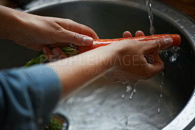 Buy stock photo Hands, carrots and washing vegetables or healthy food in sink, preparing meal and kitchen while ready to cook.  Person, rinsing fresh produce in basin at home for diet or organic recipe for wellness