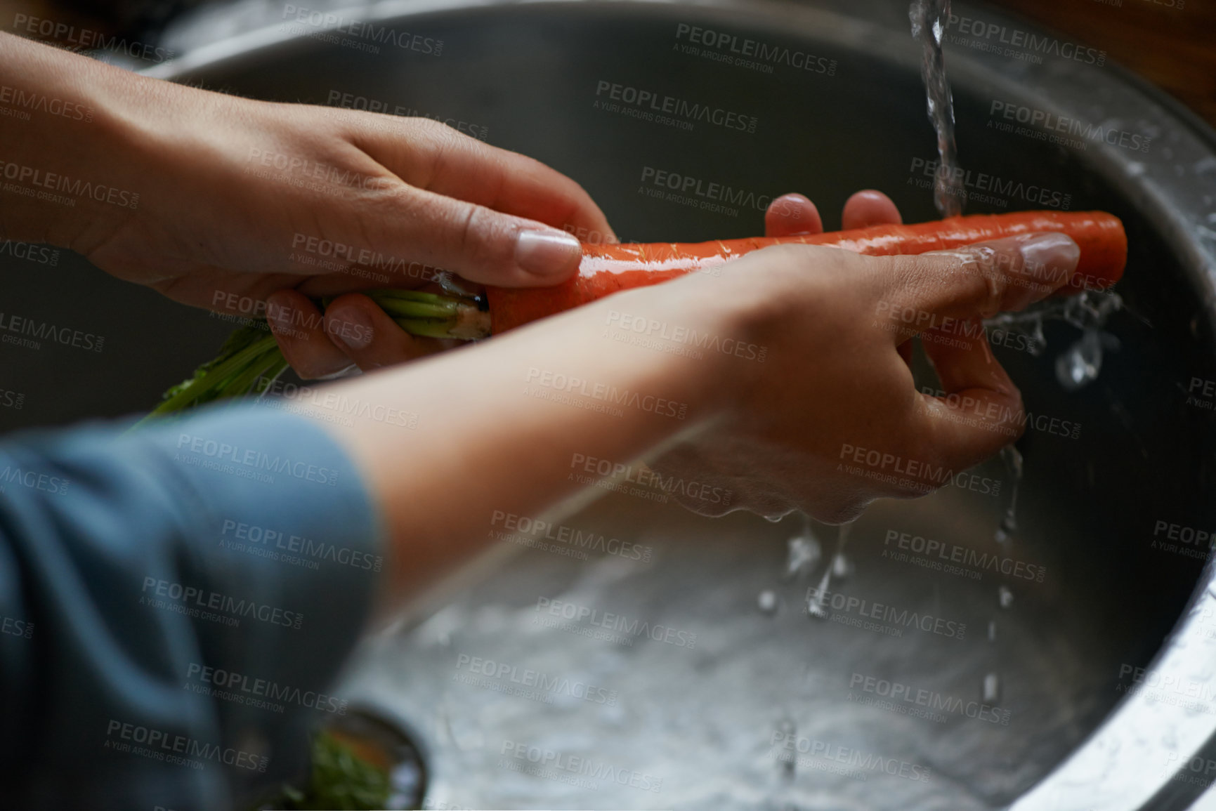 Buy stock photo Hands, carrots and washing vegetables or healthy food in sink, preparing meal and kitchen while ready to cook.  Person, rinsing fresh produce in basin at home for diet or organic recipe for wellness