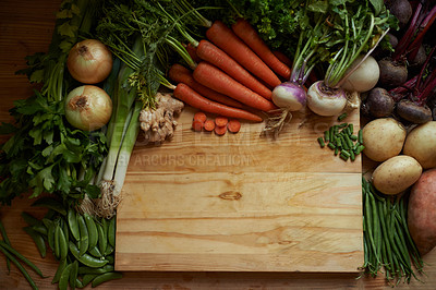 Buy stock photo Vegetables, kitchen and empty cutting board for healthy food, cooking and preperation on table above. Culinary, organic and green groceries for vegan or vegetarian recipe and ingredients background