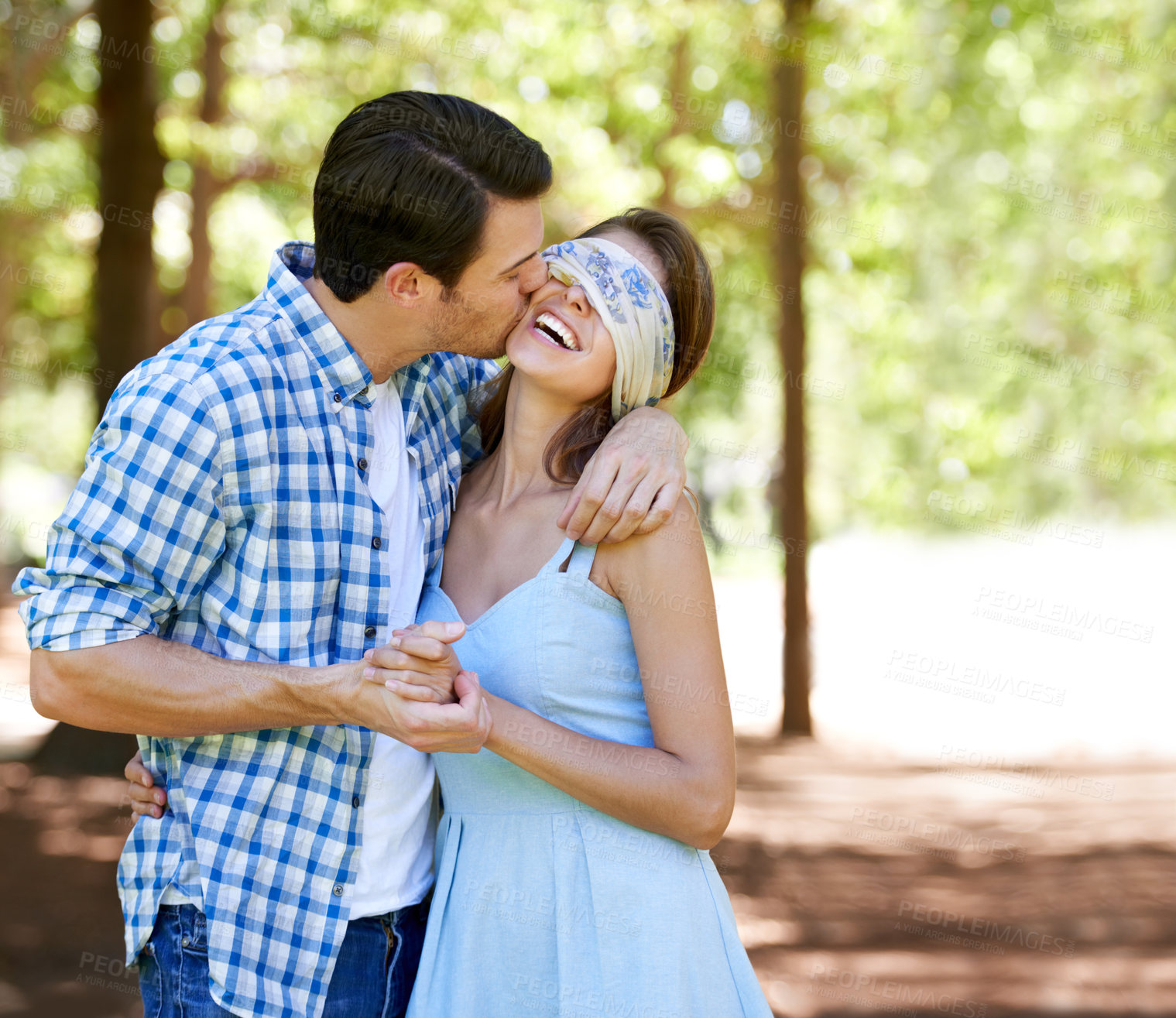 Buy stock photo A blindfolded young woman laughing with her boyfriend in the park