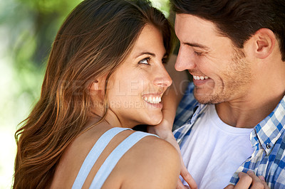 Buy stock photo Closeup of a young couple loving in the park, and standing in the summer sun under the tree. Cheerful, bonding outdoor and romantic partners affectionate and playful smiling on vacation in nature 
