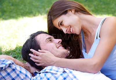 Buy stock photo Man, woman and relax in park for holiday in summer bonding or weekend, happiness or outdoor. Happy couple, smile and embrace on blanket on grass lawn for dating connection or rest, love or London
