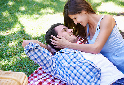 Buy stock photo Man, woman and relax in park for picnic on holiday for summer bonding, happy or outdoor. Couple, smile and embrace on blanket on grass for valentines day or dating connection or rest, love or weekend