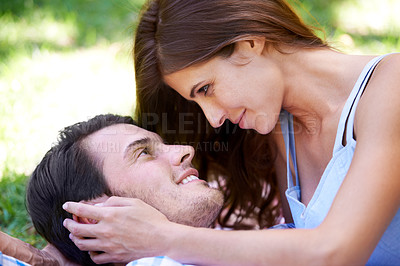 Buy stock photo Couple, smile and picnic on grass with embrace for bonding, love and sunshine in park outdoors. Happy, man and woman in love with intimacy for connection, romance and healthy relationship together