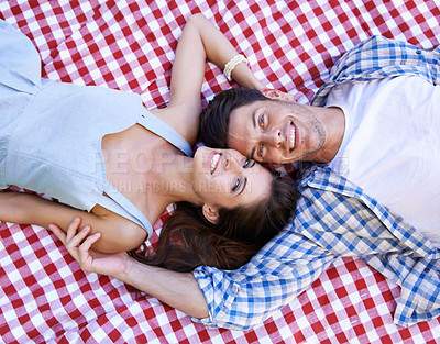 Buy stock photo Happy, couple and blanket in portrait for picnic with love, connection and bonding on date from above. Man, woman and face with relax on ground for vacation, unity or holiday in relationship together