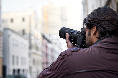 Buy stock photo A young man taking a picture with his camera