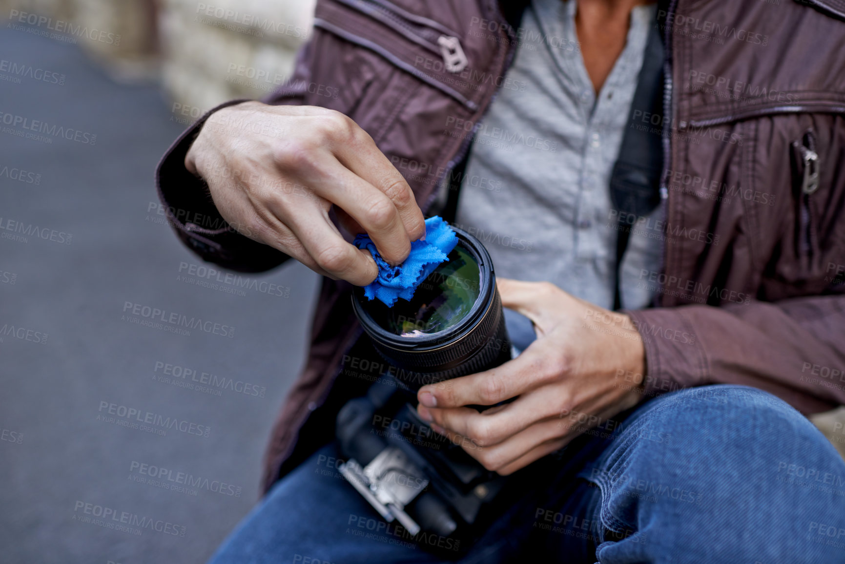 Buy stock photo A young man removing the lens from his camera