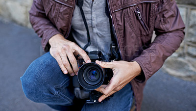 Buy stock photo A young man removing the lens from his camera