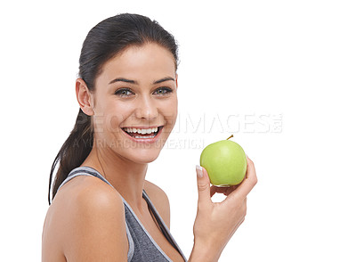 Buy stock photo Studio portrait of a fit young woman holding an apple