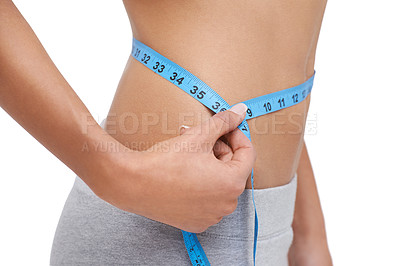 Buy stock photo Studio shot of a woman measuring her waistline