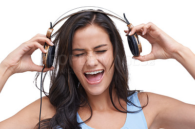 Buy stock photo Studio shot of a young woman listening to music on her headphones against a white background