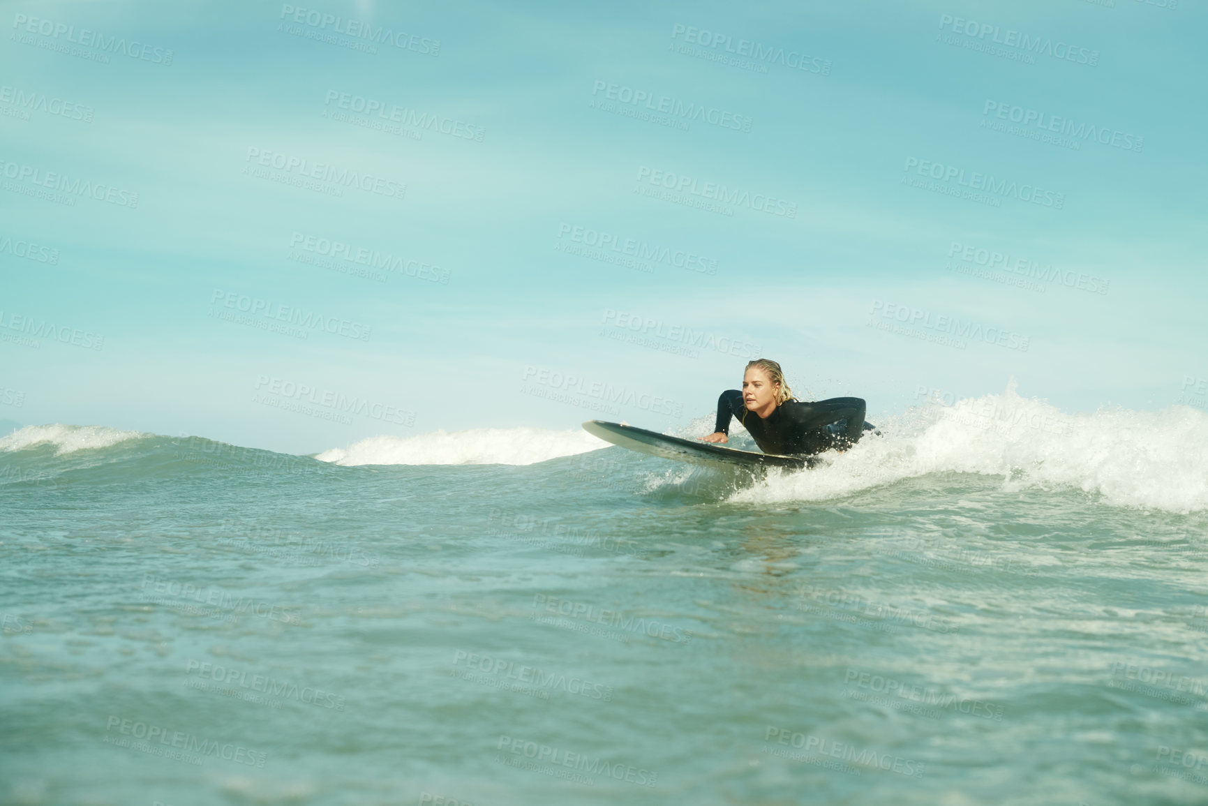 Buy stock photo Summer, sports and woman on surfboard in sea with space for outdoor travel, vacation or holiday. Ocean, wave and splash with young surfer person outdoor on blue sky for fitness, exercise or training