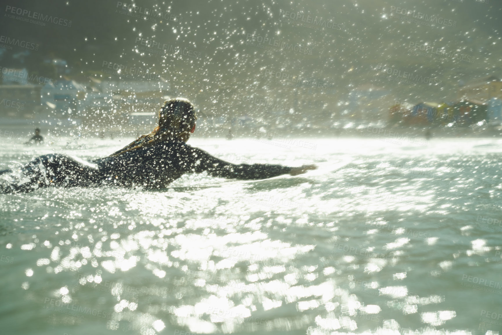 Buy stock photo Swimming, splash and woman on surfboard in ocean for fitness, exercise or recreation in summer. Sports, travel or training with surfer person in sea for vacation, holiday or leisure hobby from back