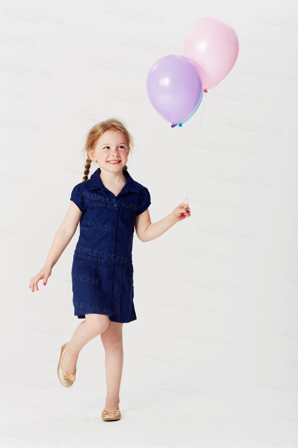 Buy stock photo Smile, balloons and girl playing in studio isolated on a white background mockup space. Happiness, air balloon and kid play games with inflatable toys, having fun and enjoying birthday celebration.