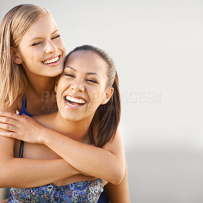 Buy stock photo A young woman enjoying a hug from her best friend