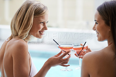 Buy stock photo Two friends tanning with cocktails in their hands