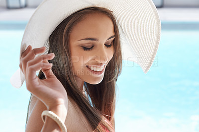 Buy stock photo Smile, face and woman at pool with hat, sunshine and travel for summer holiday at hotel. Relax, water and happy girl on luxury vacation with adventure, weekend and swimming at in sun at resort.