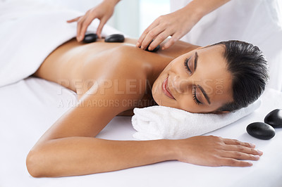 Buy stock photo Relax, calm and woman with hot stone massage at spa for health, wellness and back treatment. Self care, sleeping and female person with warm rock skin therapy with masseuse at natural beauty salon.