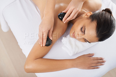 Buy stock photo Hot stone, woman and hands massage in top view for skincare, beauty and pamper shoulder for wellness at salon. Therapist, rocks and person at spa for treatment, body and relax with masseuse above