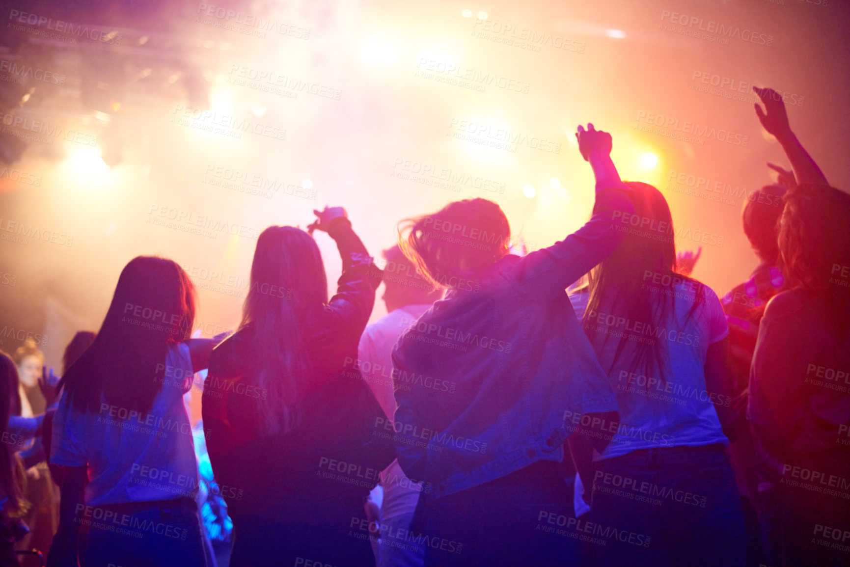 Buy stock photo Crowd, people dancing at concert or music festival from back, neon lights and energy at live event. Dance, fun and group of excited fans in arena at rock band performance or audience at rave party.