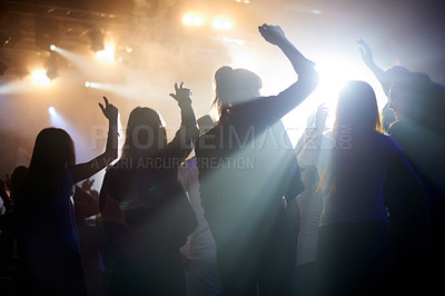 Buy stock photo Dance, silhouette of people at music festival from back, lights and energy at live concert event. Dancing, fun and group of excited fans in arena at rock band performance or friends at party together