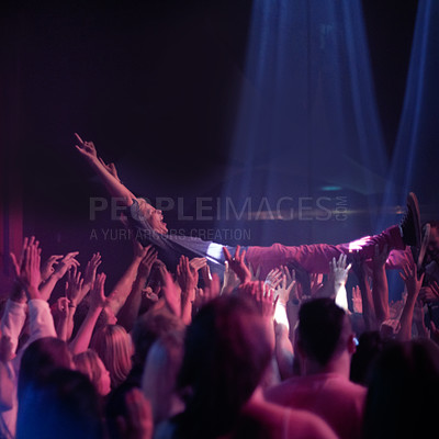 Buy stock photo Crowd surf, people at music festival or rock concert, neon lights and energy at live show event. Support, fun and group of excited fans in arena at band performance and person on hands of audience.