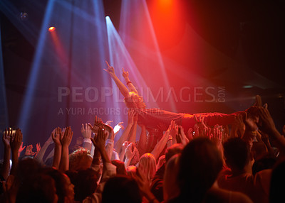 Buy stock photo Crowd surf, light and people at music festival, neon lights and energy at live concert event. Dance, fun and group of excited fans in arena at rock show performance, audience carrying fan on hands.