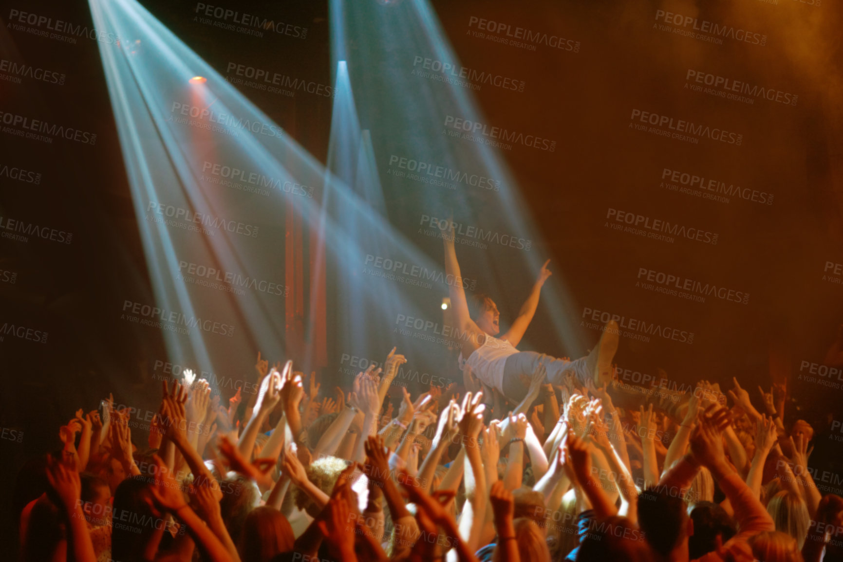 Buy stock photo Stage dive, hands and people at music festival, neon spotlight and energy at live concert event. Dance, fun and group of excited fans in arena at rock show performance, audience carrying crowd surfer