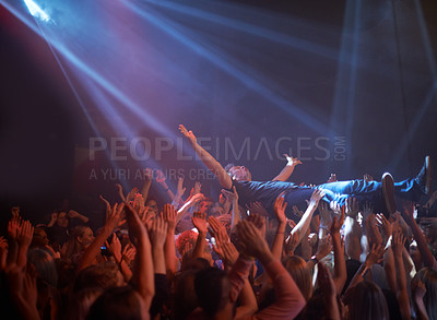 Buy stock photo Crowd surfing, lighting and people at rock concert or music festival, neon lights and energy at live event. Dance, fun and group of excited fans in arena at rock show performance, audience stage dive