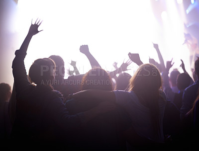 Buy stock photo Group of people dancing at music festival from back, lights and energy at live concert event. Dance, fun and crowd of excited fans in arena at rock band performance or audience at party in silhouette
