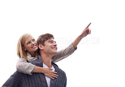 Buy stock photo Couple, piggy back and outdoor with pointing, smile and direction on vacation, walk and adventure. Man, woman and hug with care, bonding and holiday with love by sky for memory on Valentines Day date